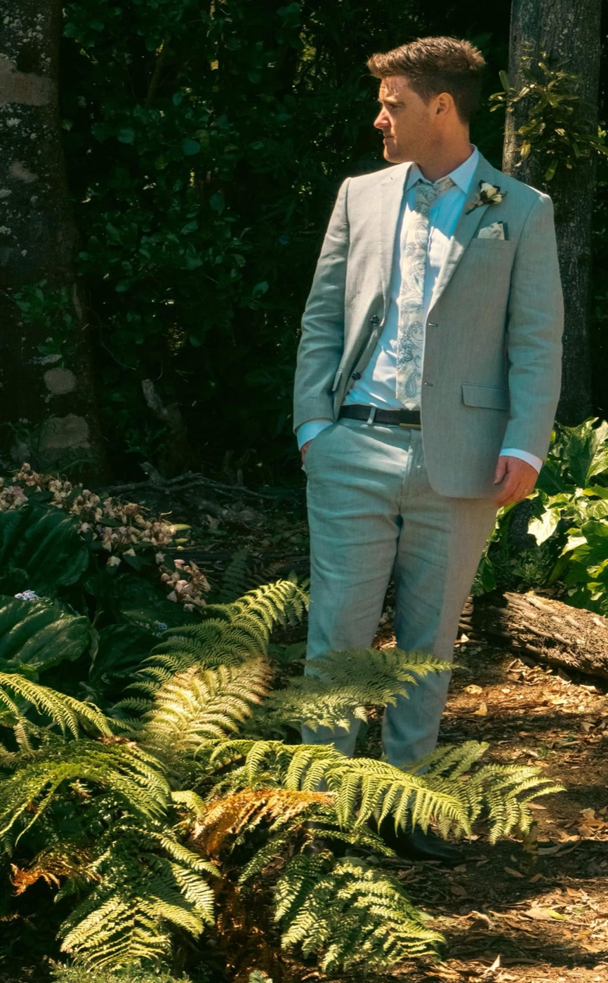 Groom suit detail among foliage