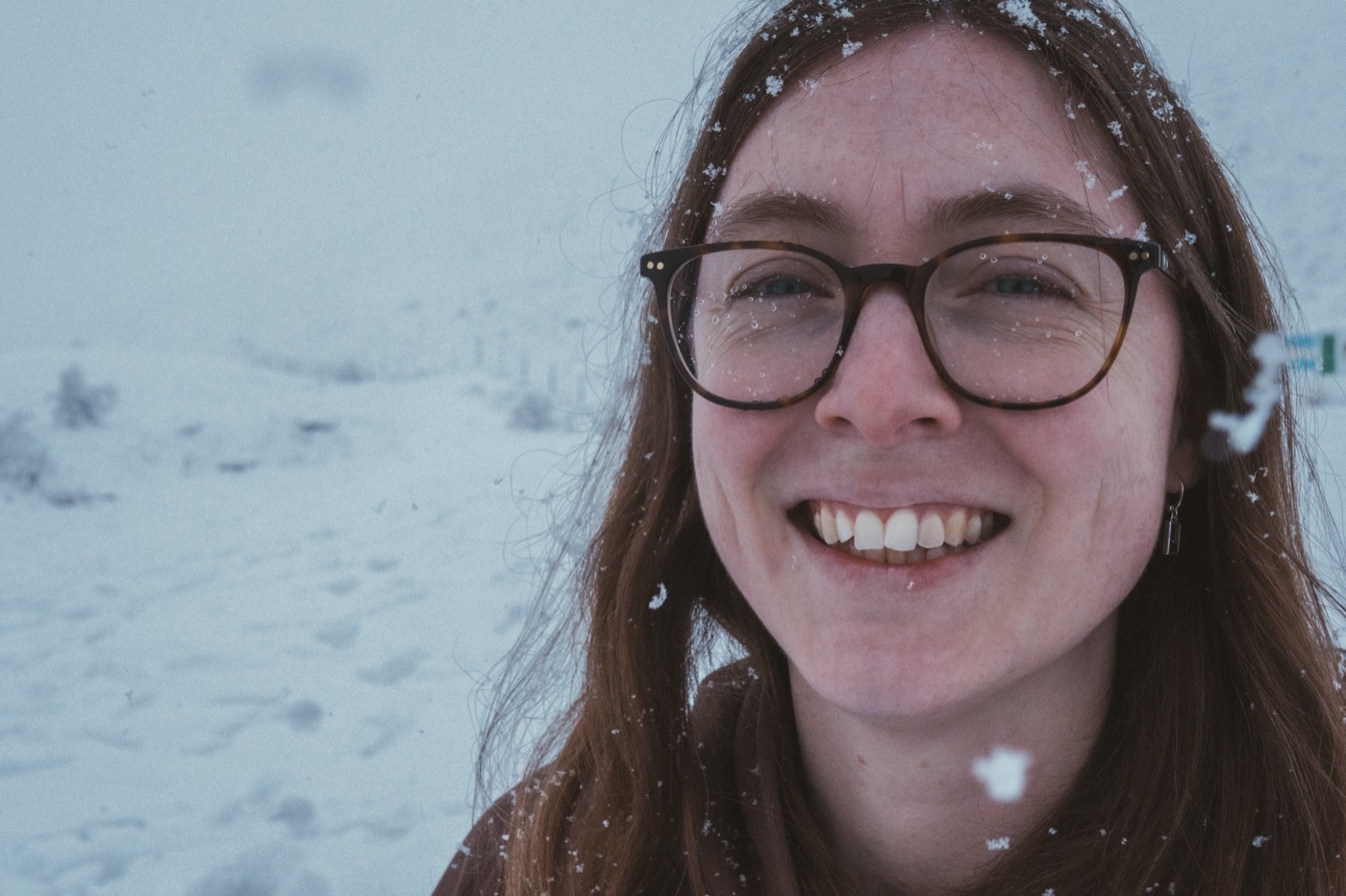 Portrait smiling in falling snow
