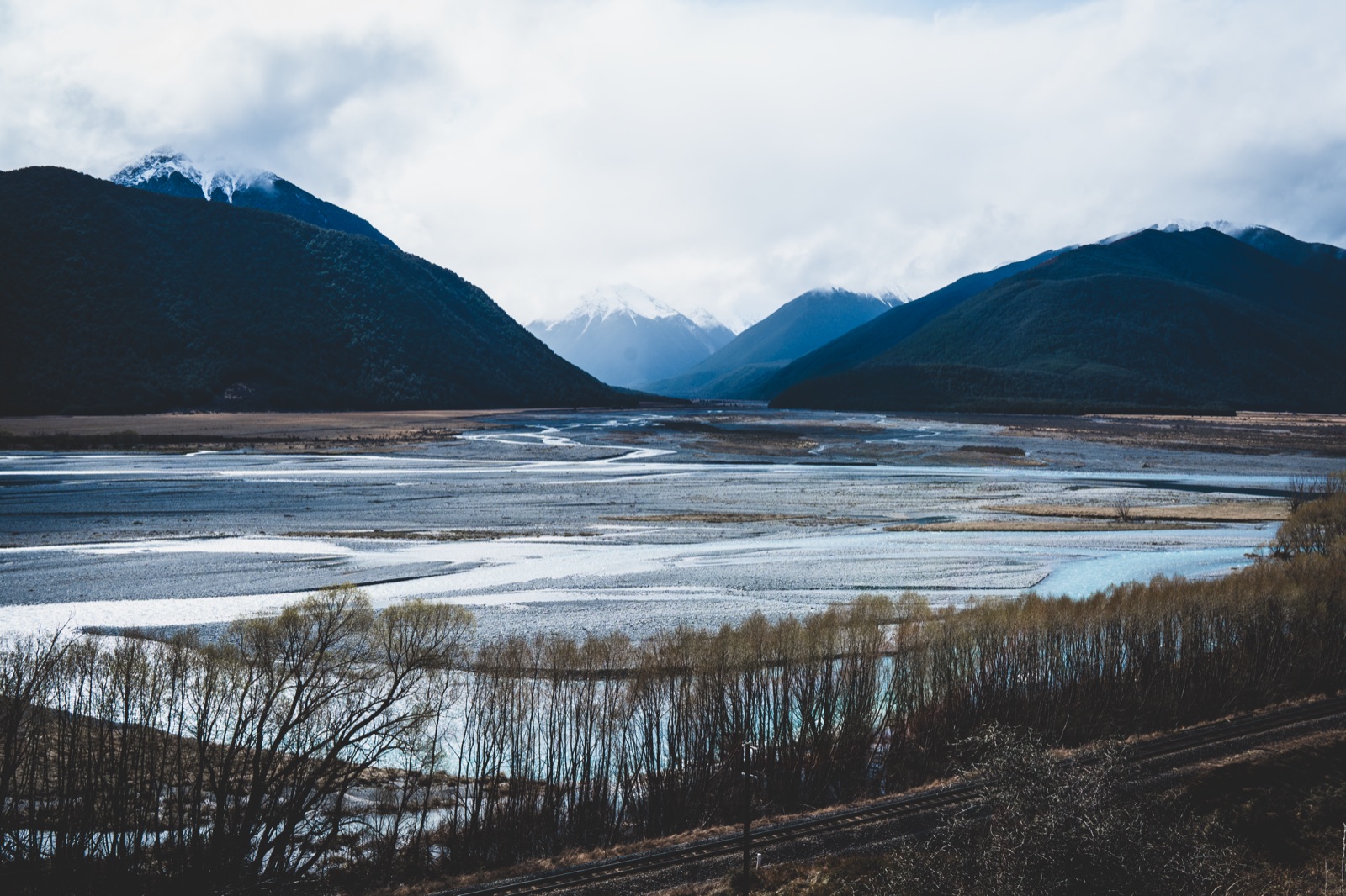 Braided river running between dark mountain ranges