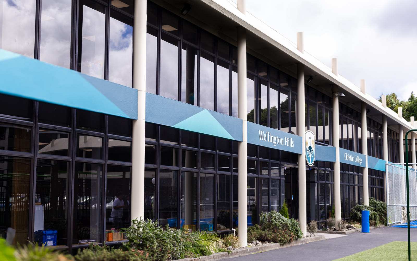 Front of the Wellington Hills Christian College building on a bright day